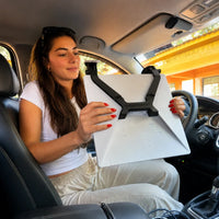 Driver fitting a black dual suction cup mount to the back of Starlink Mini